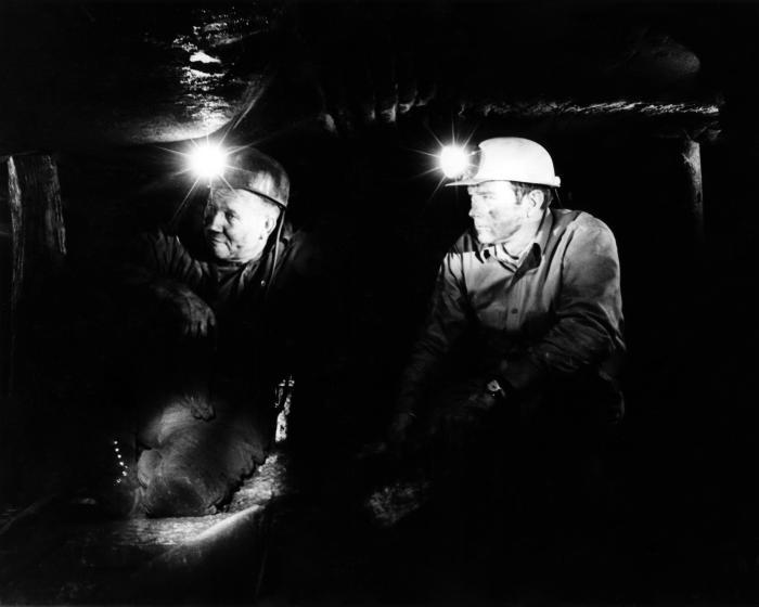 Two men inside a coal mine