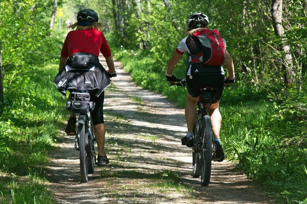 Two people riding bicycles on a path