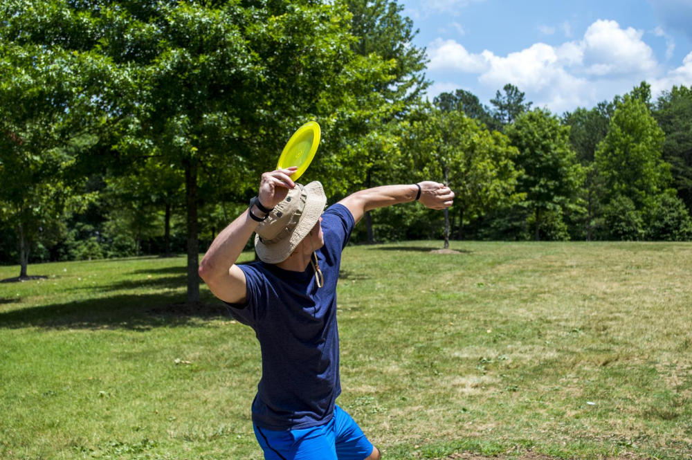 A person throwing a disc on a course
